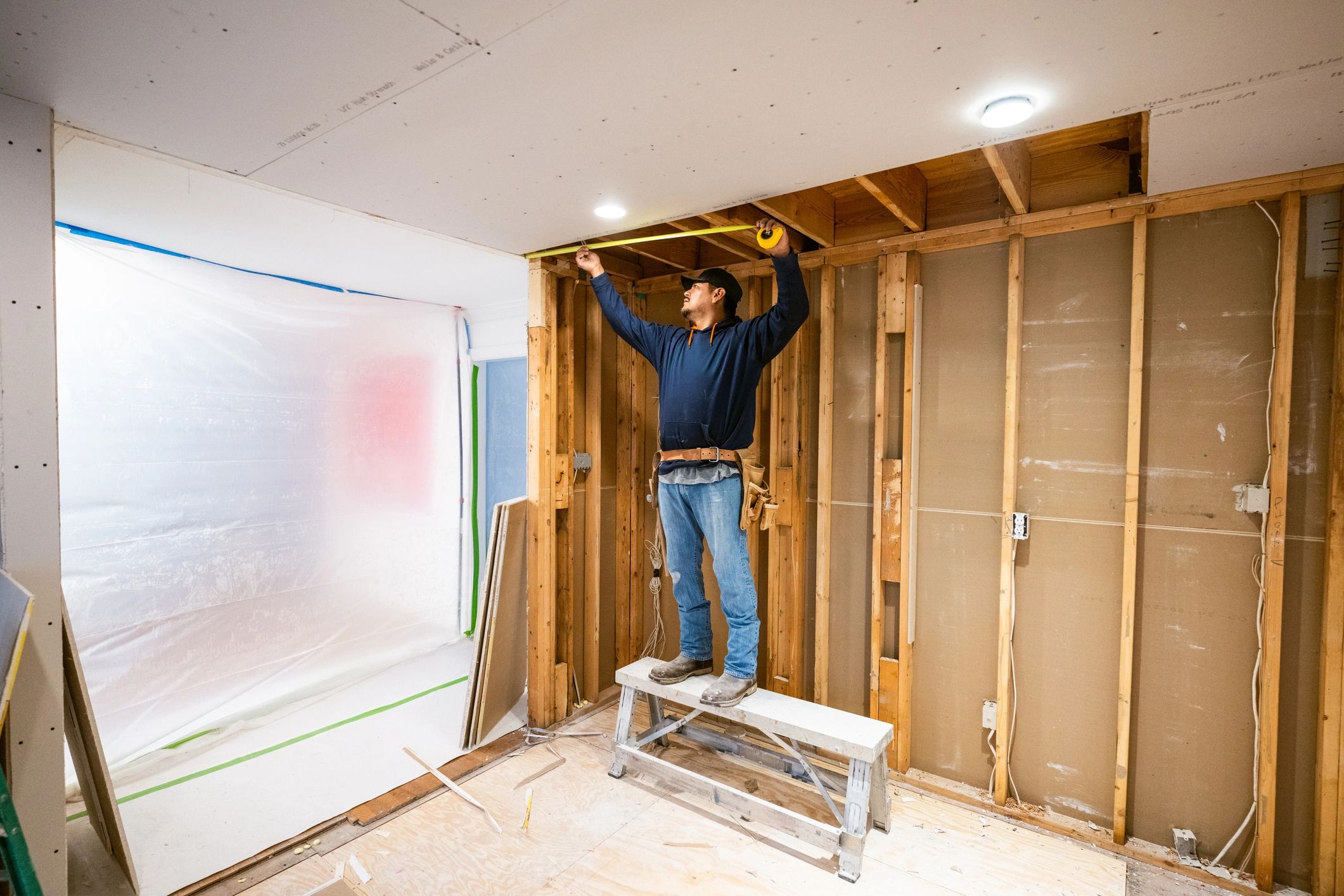 Drywall installers working in a kitchen renovation