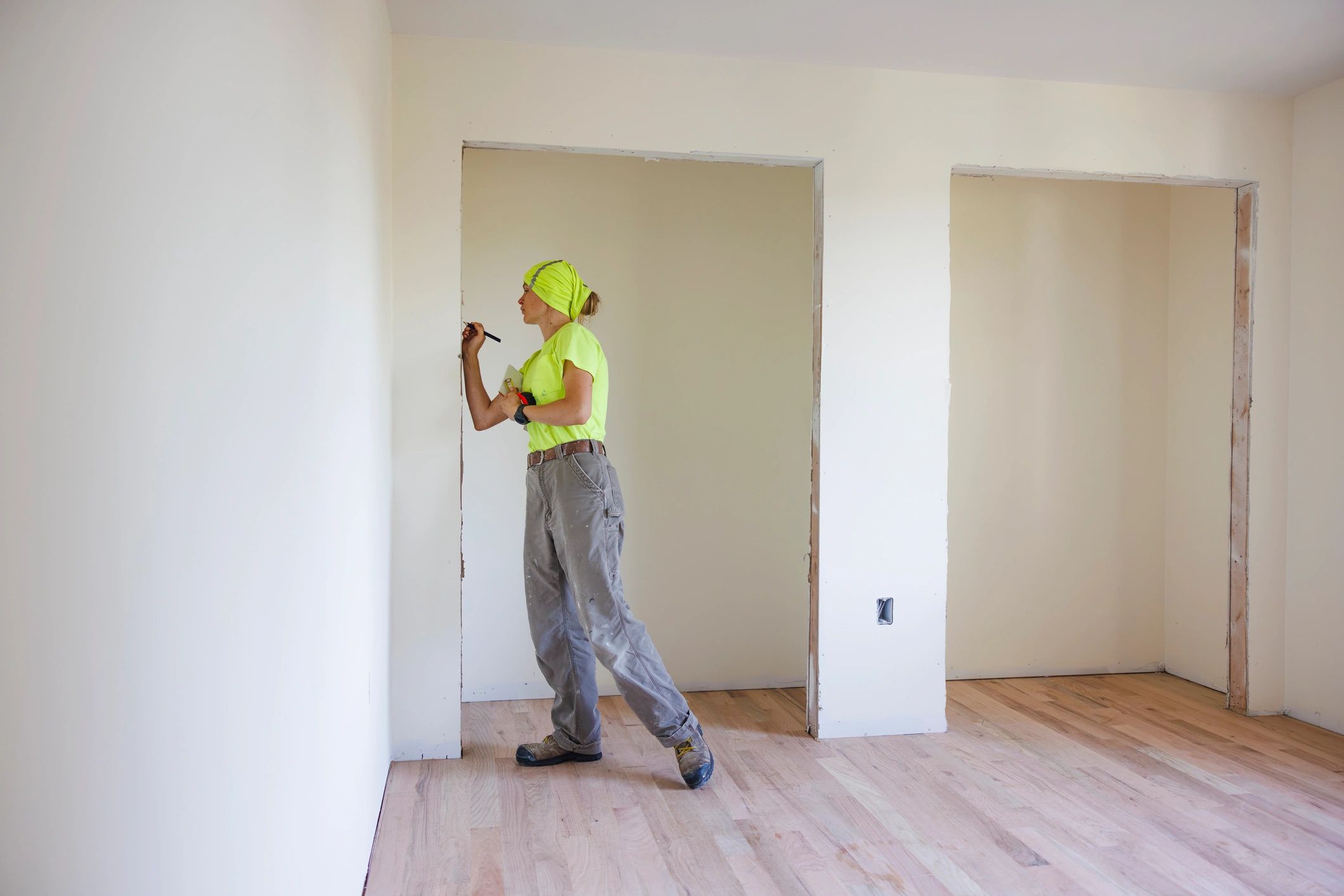 Contractor measuring a doorway during a remodel
