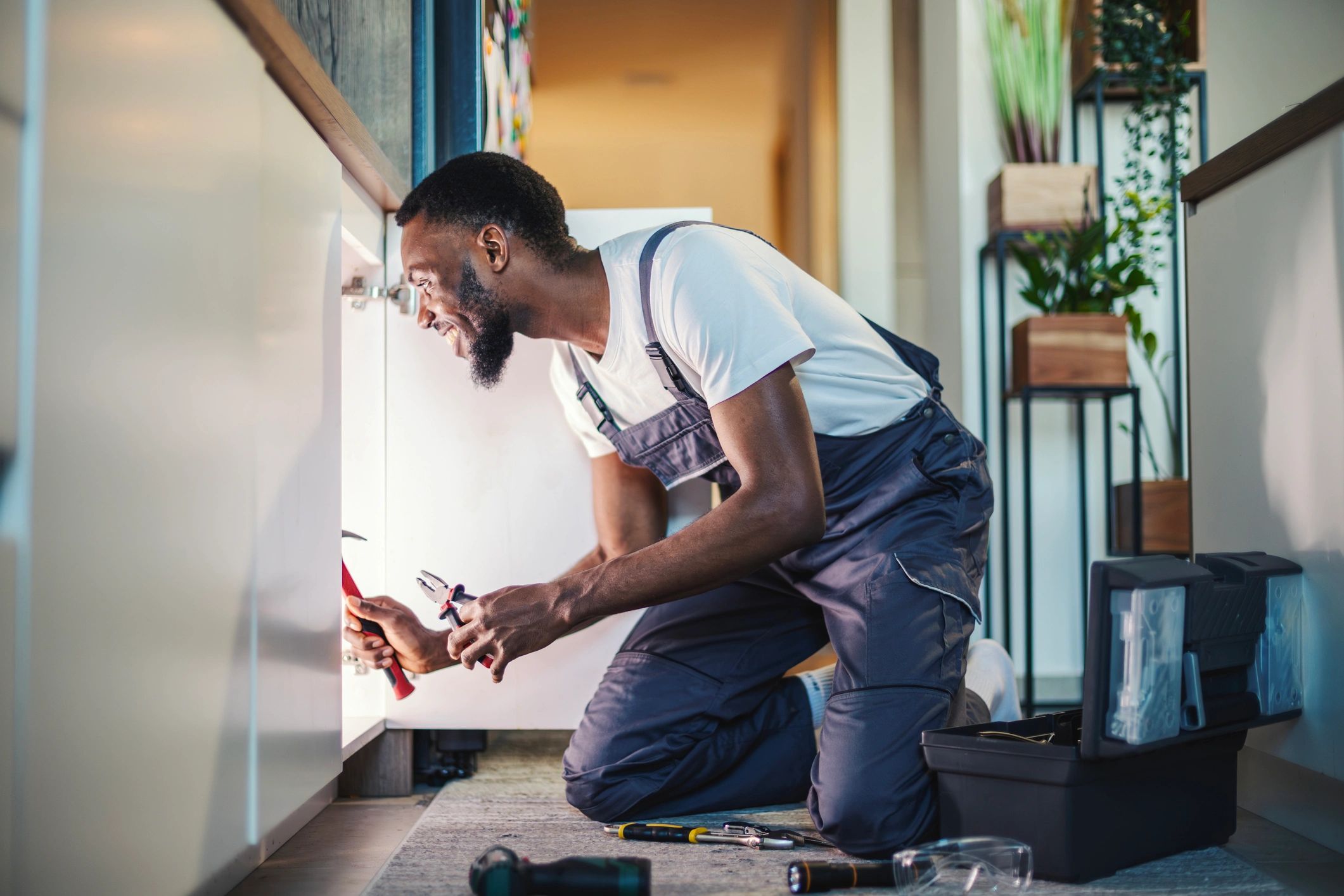 Handyman working under a kitchen sink
